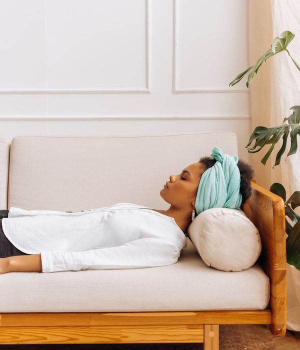 Woman in a calm, balanced yoga pose, surrounded by soft light.