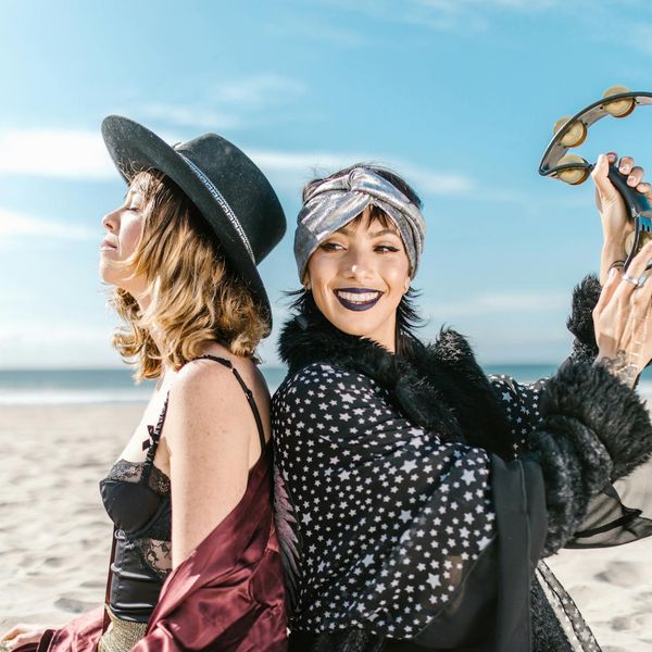 Woman performing an energetic yoga flow with a radiant smile.